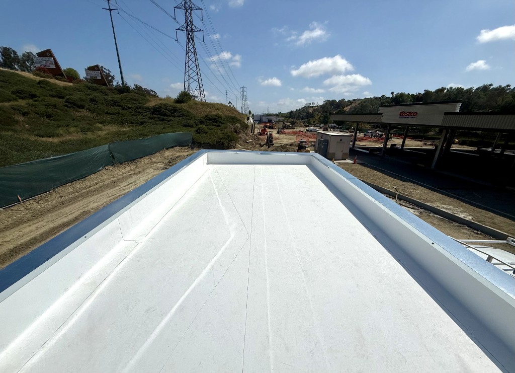 Commercial flat roof with custom metal coping along the parapet edge